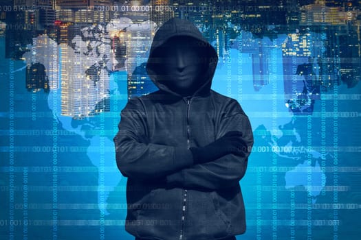 Hooded hacker with mask working out against binary code background