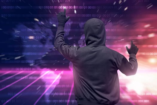 Rear view of hooded hacker using virtual screen to hacking internet system security