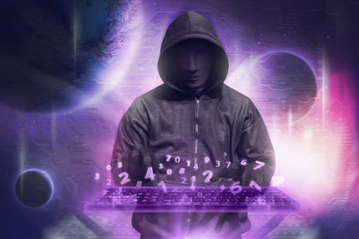 Hacker in mask typing keyboard hacking binary data system security