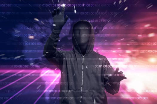 Hooded hacker with mask hacking binary system security code on the virtual screen