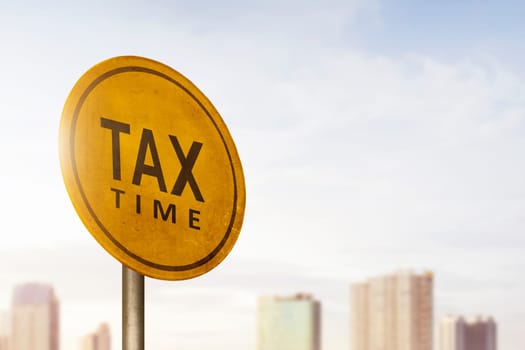 Tax time announcement on road sign with sky background