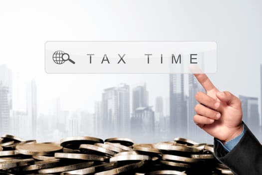 Business hand touching search engine bar with taxes keyword on virtual screen