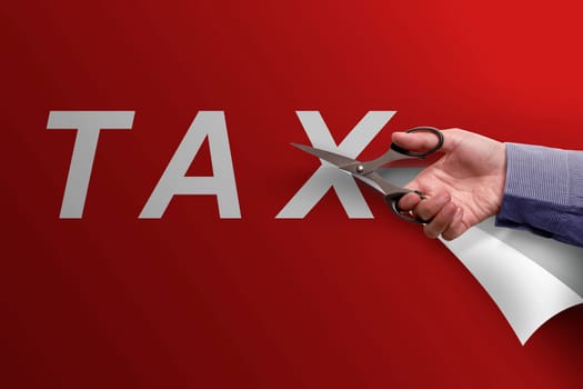 Business hand with scissors cutting Tax word on red paper