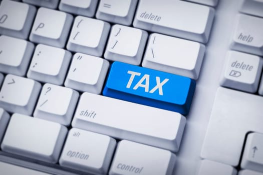 Computer keyboard with different tax button. Tax time concept.
