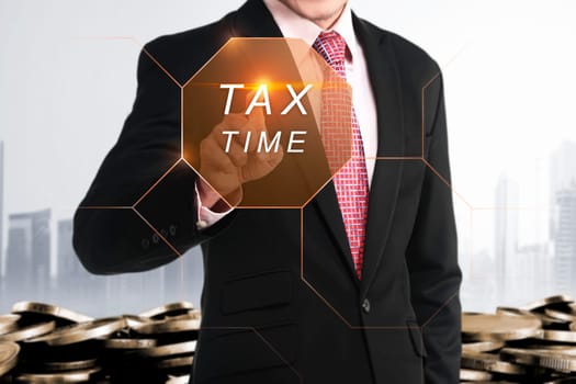 Businessman hand touching Tax Time button on virtual screen