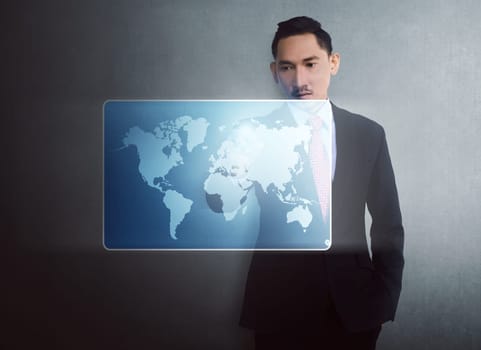 Modern asian businessman touching virtual world map on digital screen over wall background