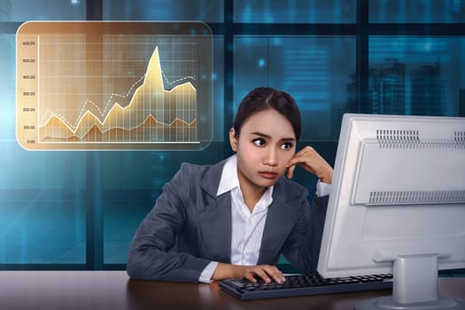 Asian business woman working with computer with virtual market chart on digital background
