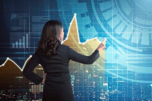 Asian business woman drawing digital graph on virtual screen background