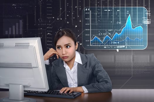 Asian business woman working with computer with virtual market chart on digital background