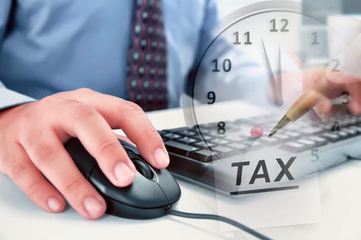 Businessman working using computer with ending time for Tax payment at office