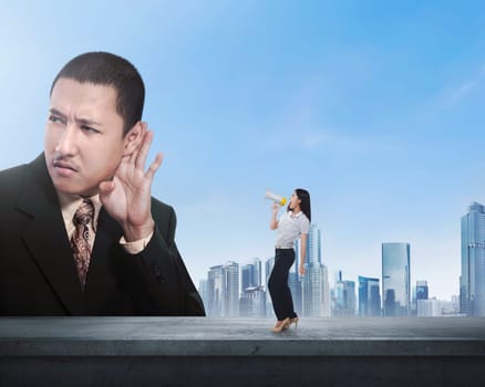 Business woman using megaphone say something to boss with cityscape background