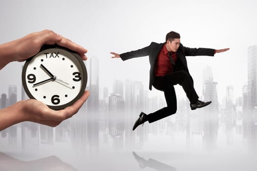 Handsome asian businessman escaping from paying tax on futuristic background.