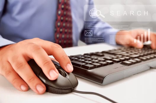 Businessman typing on keyboard working at his workplace