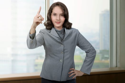 Young asian business woman showing something in the office room