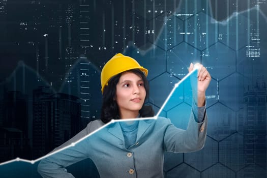 Asian architect woman with yellow hat drawing virtual chart in the digital screen