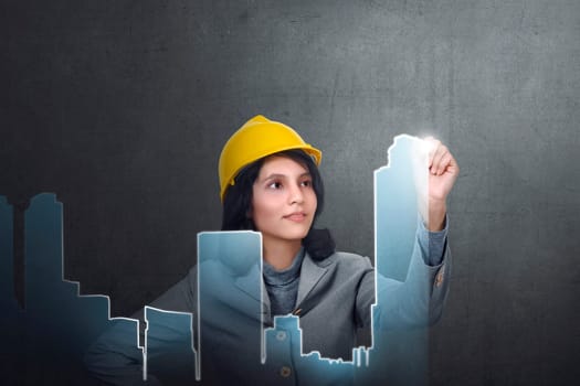 Asian constructor woman with safety helmet create urban planning on virtual screen
