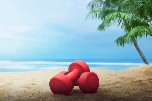 Red dumbbells for exercise on the beach