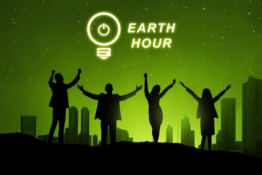 Silhouette of business people with Earth hour message over cityscape background