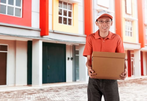 Smiling asian delivery man holding package to delivered