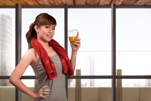 Young asian woman drinking a healthy natural juice for healthy with window glass background