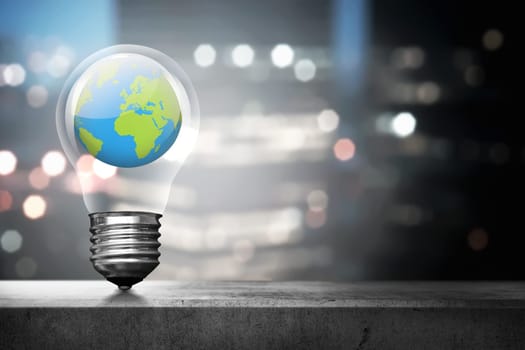 Portrait of earth inside light bulb over blurred light city background