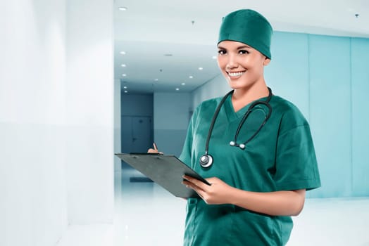 Asian female doctor smiling over hospital background