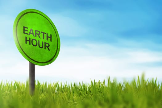 Earth Hour greeting on traffic sign in meadow field background