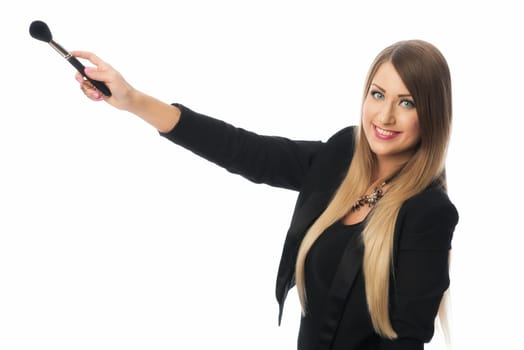 woman holds many cosmetic brushes in her hands