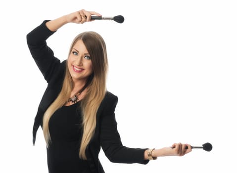 woman holds many cosmetic brushes in her hands