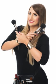 woman holds many cosmetic brushes in her hands