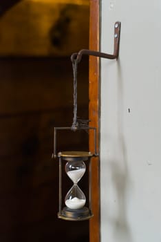 antique hourglass on an old sailboat