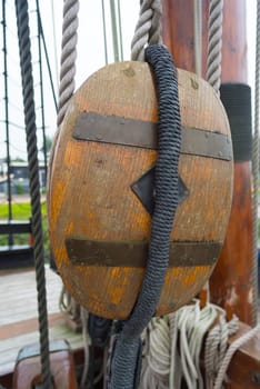 ancient wooden sailboat pulley on an old restored dutch VOC ship