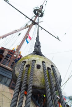 ancient wooden sailboat pulley on an old restored dutch VOC ship