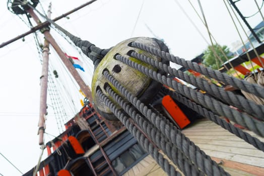 ancient wooden sailboat pulley on an old restored dutch VOC ship