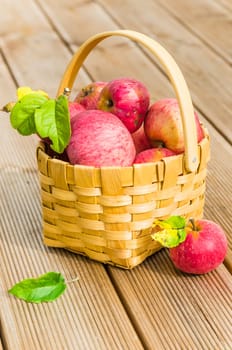 Basket with ripe red apples, close-up