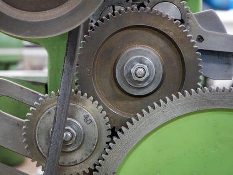 Various gears on a mechanical lathe.