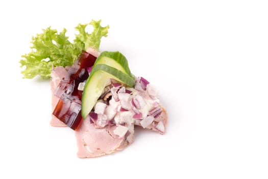 Danish specialties and national dishes, high-quality open sandwich. Sandwich with pork roll sausage, rullepoelse, , jelly and raw red onions, isolated on white background
