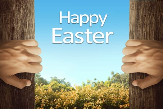 People hand opening door with happy easter greetings on forest