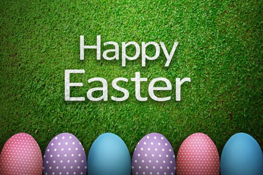 Happy easter greeting with easter egg over green grass background