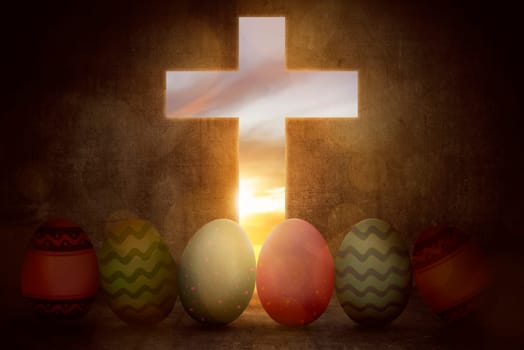 Bright colorful easter eggs from light cross on sunset