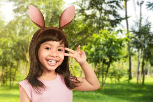 Young girl with bunny ears in the garden