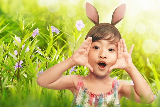 Happy girl expression with bunny ears in the garden
