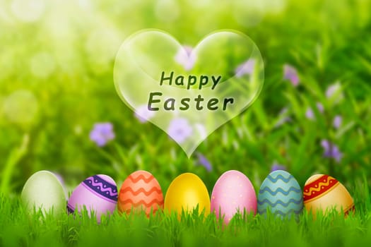 Colorful Easter eggs with fresh green grass on the garden