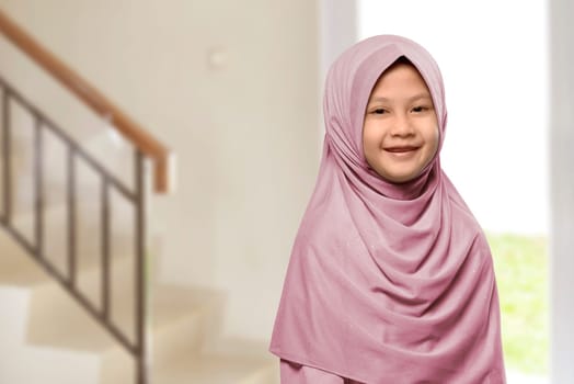 Little asian muslim girl with hijab at home