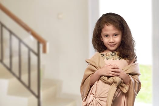 Asian muslim kid with traditional dress in the home