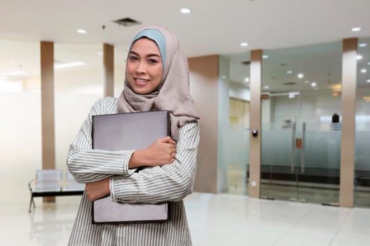 Young asian muslim woman working with laptop in the office
