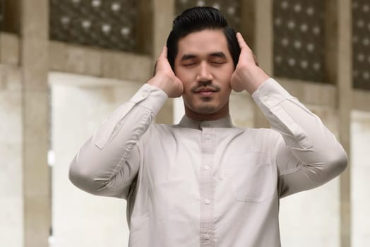Portrait of asian muslim man praying in the mosque