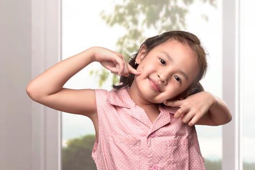 Cheerful asian little girl having fun in the home