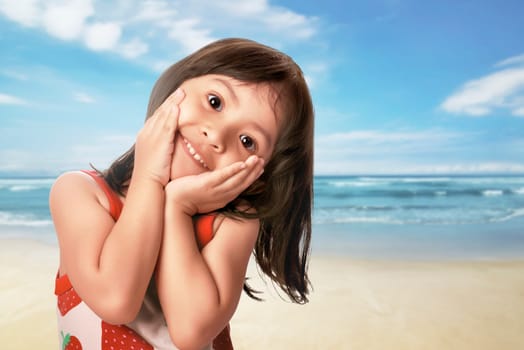 Beautiful asian child with funny expression in the beach