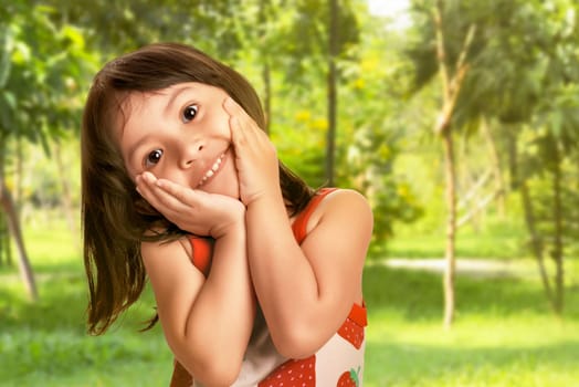 Little asian girl with is happy and excited face on spring park